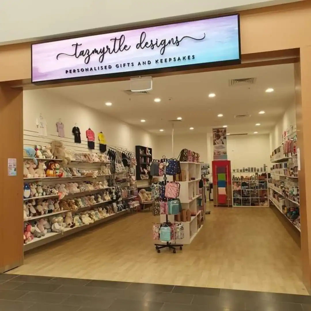 Personalized gift shop with shelves of colorful plush toys and accessories.